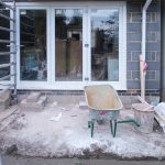 A construction site showcasing home renovation with scaffolding and tools.