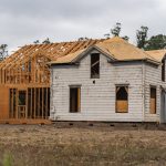 Image of an old house under renovation with new wooden frame structure.