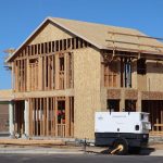 A new house under construction in Elk Grove, showing wooden framing and building materials.
